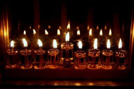 Lighting the oil in a hanukia for Hanukah