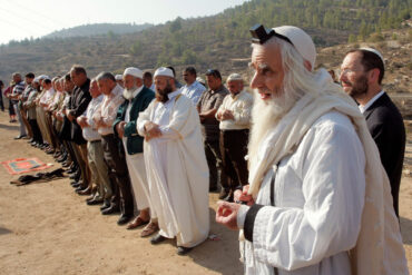 Rav Menaḥem Froman leading a joint prayer between Palestinians and Jewish "settlers"