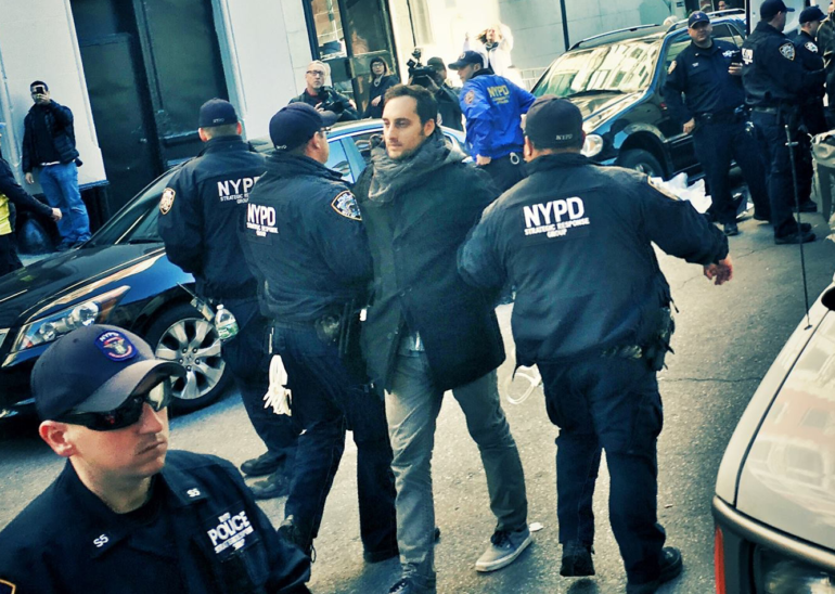 Yotam Marom being led away by police