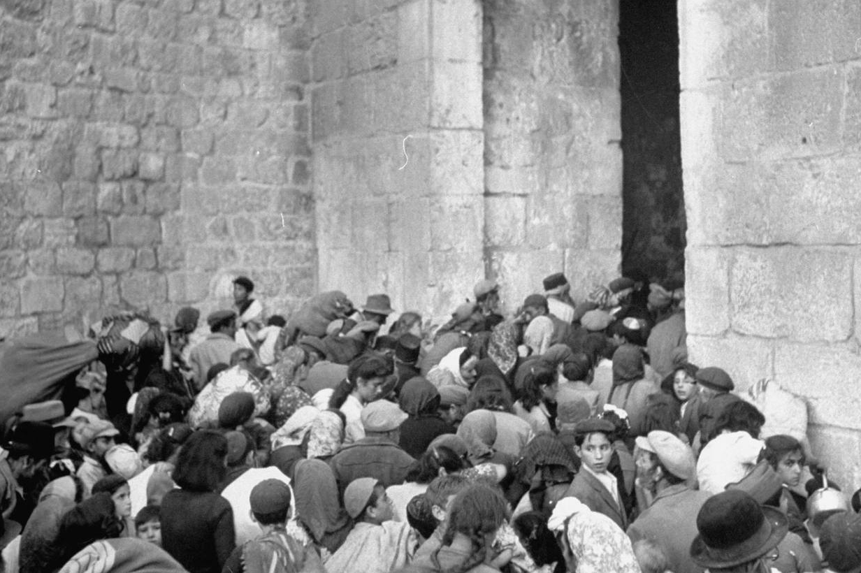 Jewish refugees fleeing the Jordanian-occupied Old City of Jerusalem through the Zion Gate in 1948