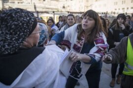 Women of the Wall and a religious Jewish woman fighting at the Kotel